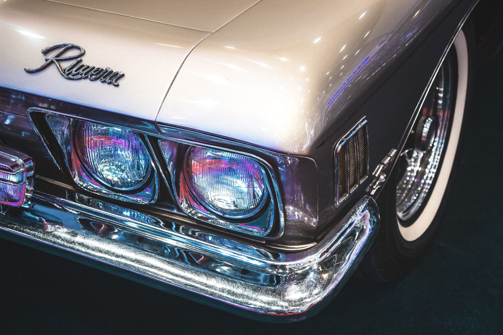 off white classic car with chrome front fender