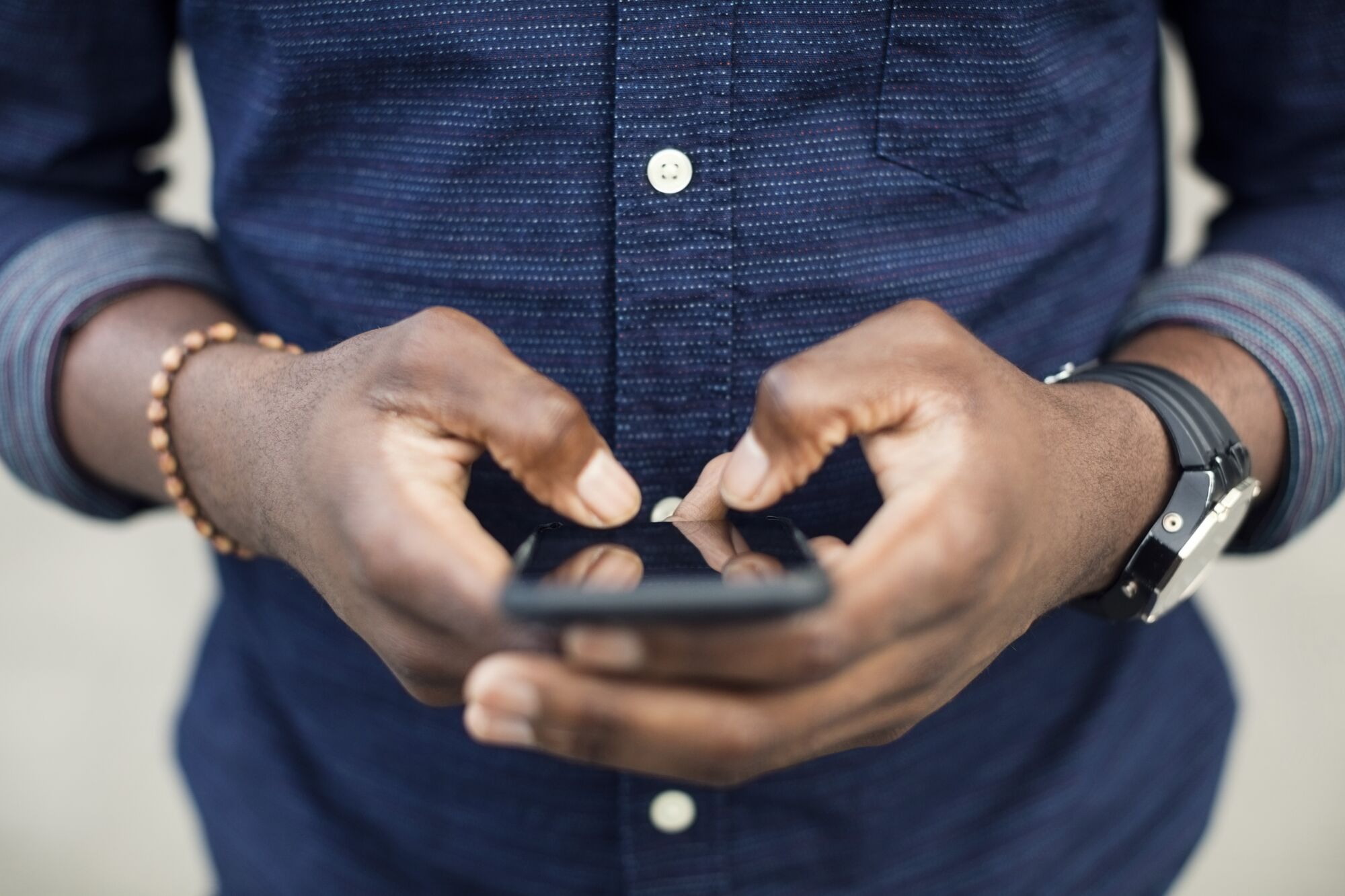 Close up of hands holding phone