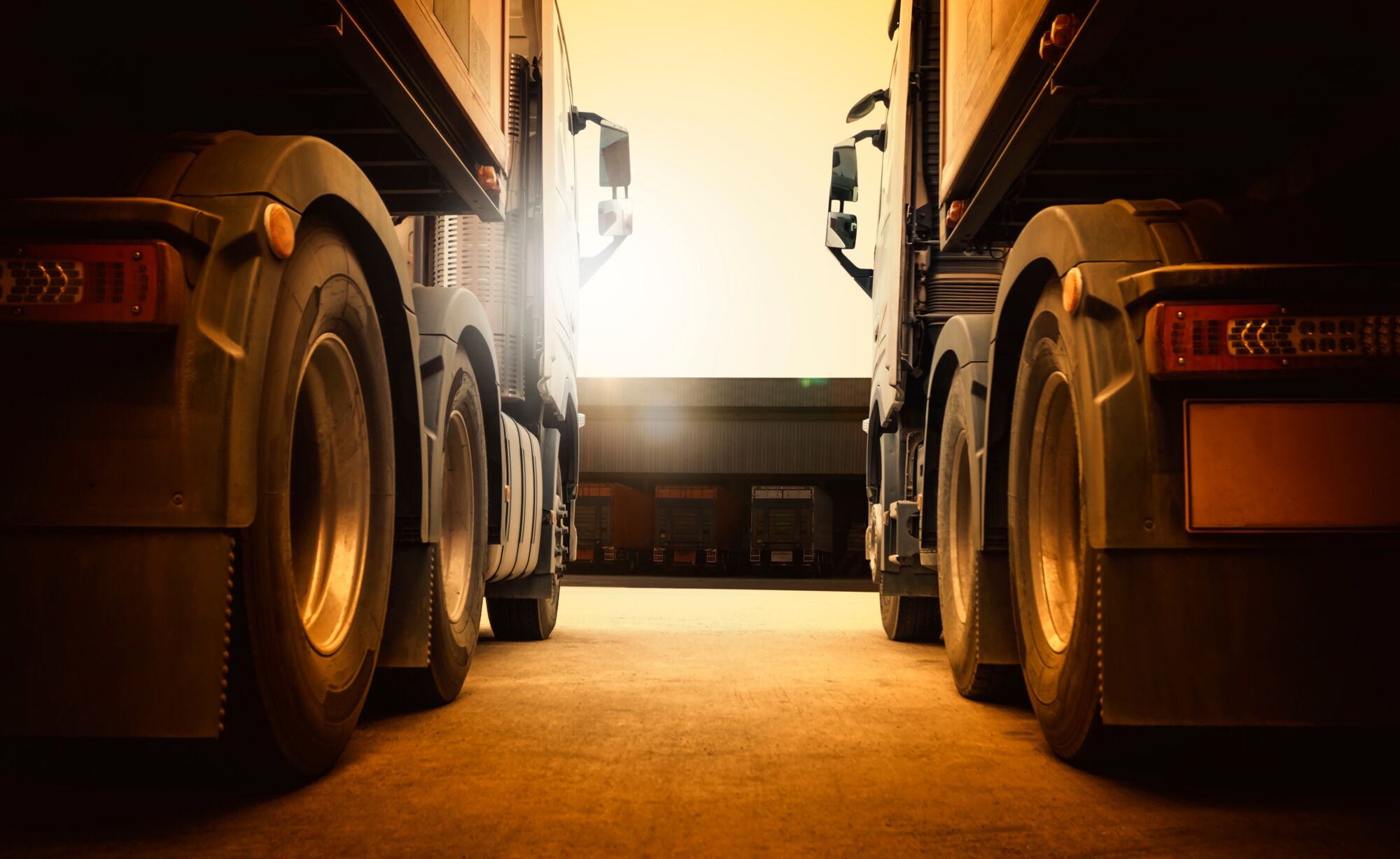 Semi Trailer Trucks on Parking at Distribution Warehouse with The Sunset. Truck Wheels Tires. Auto Service Shop. Shipping Trucks. Lorry Tractor. Industry Freight Trucks Logistics Cargo Transport..