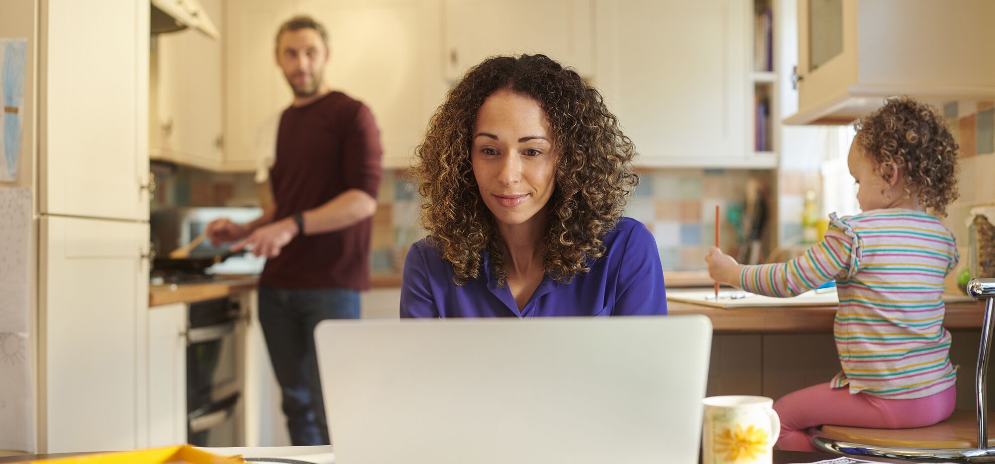 Woman working from home in kitchen