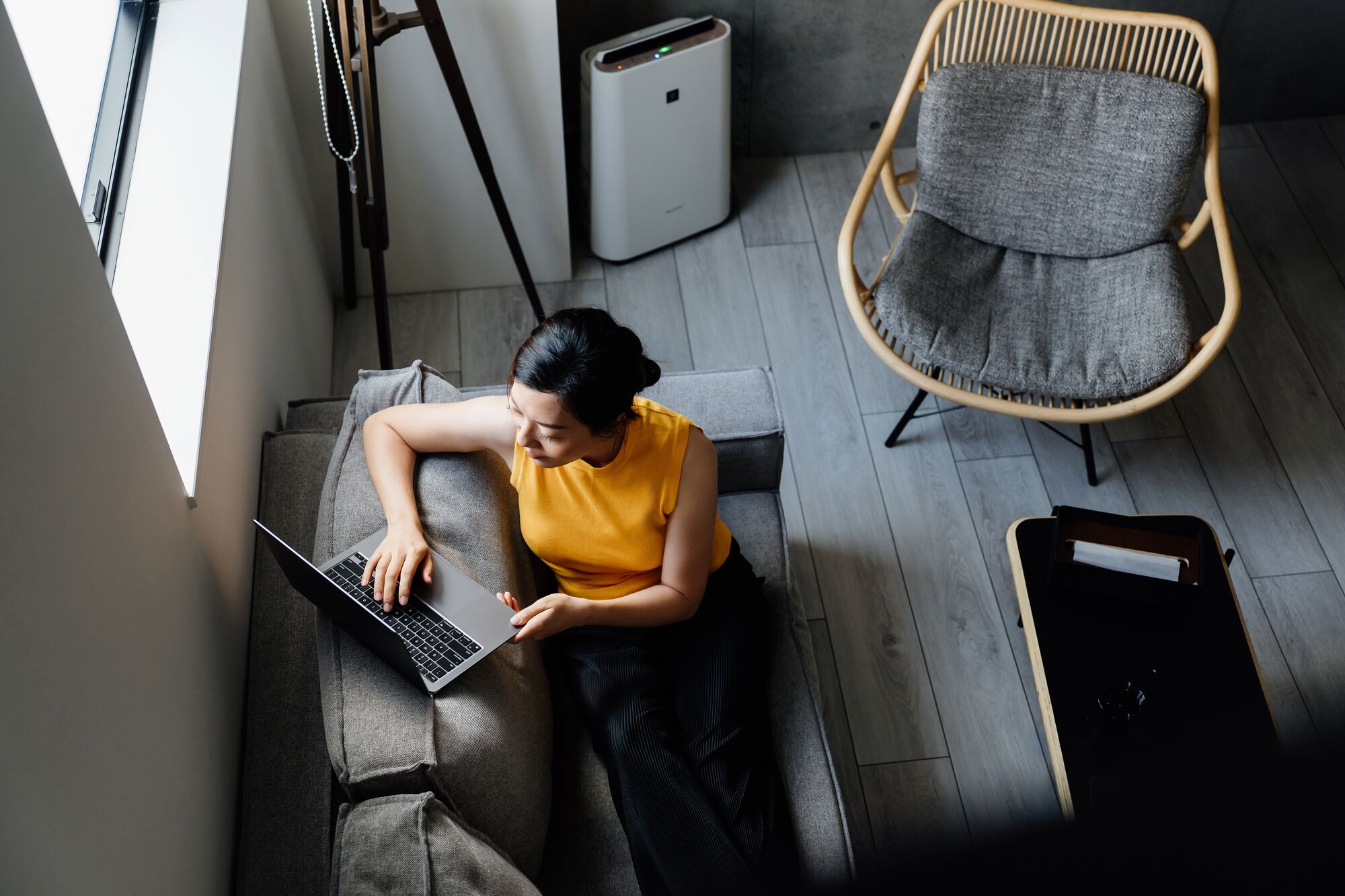 High angle shot of young businesswoman using laptop while working from home