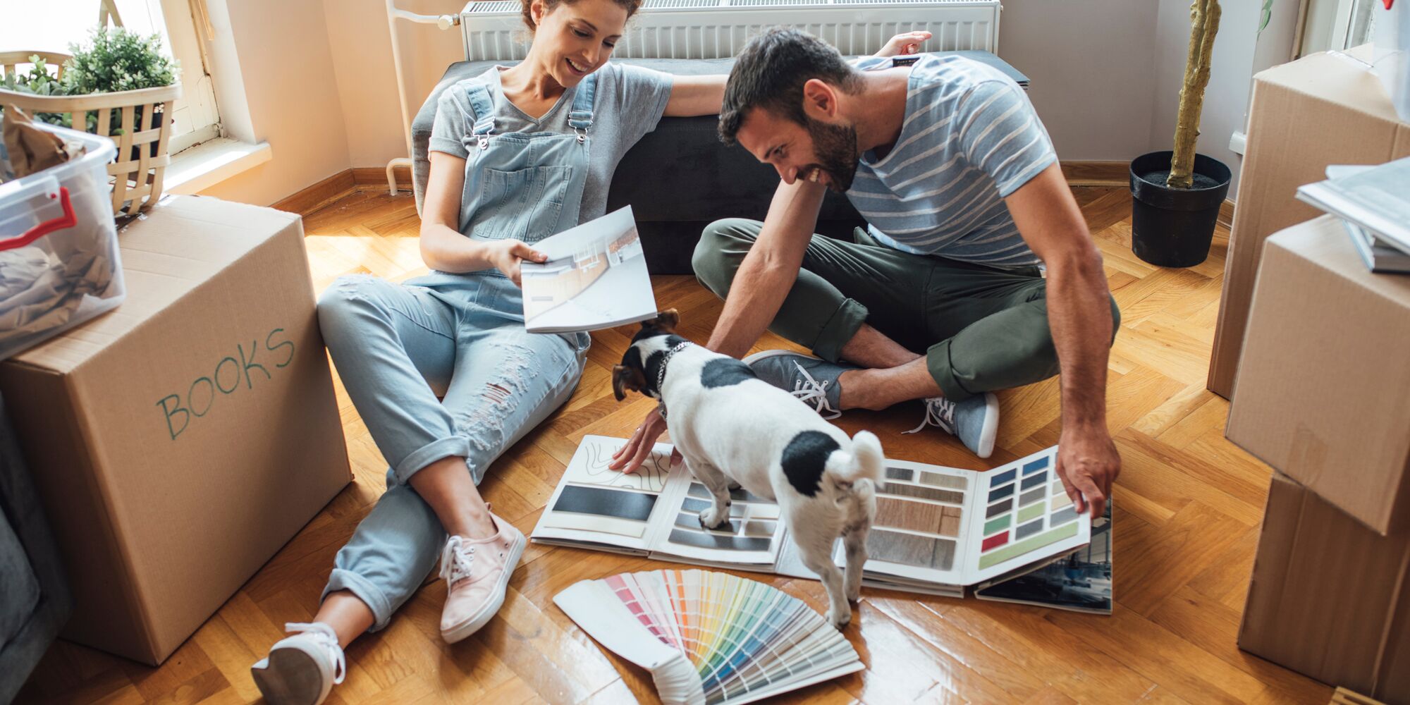 Husband and wife and their dog moving in new home.
