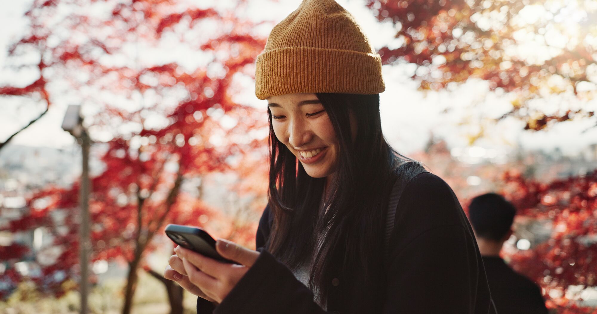 Young woman in park for holiday, vacation and adventure in Japan