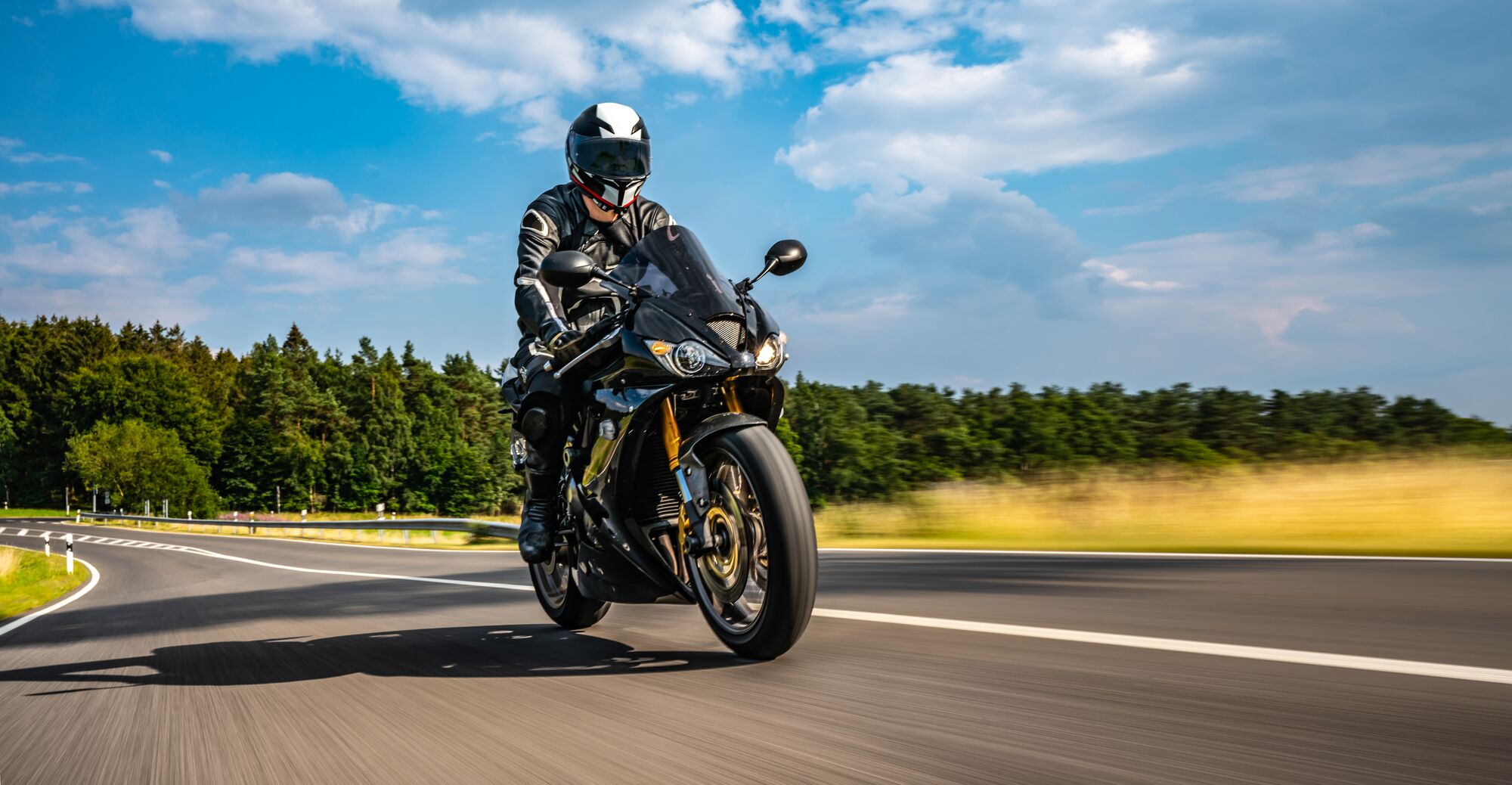 motorbike on the road riding. having fun driving the empty road on a motorcycle tour journey. copyspace for your individual text. Fast Motion Blur effect