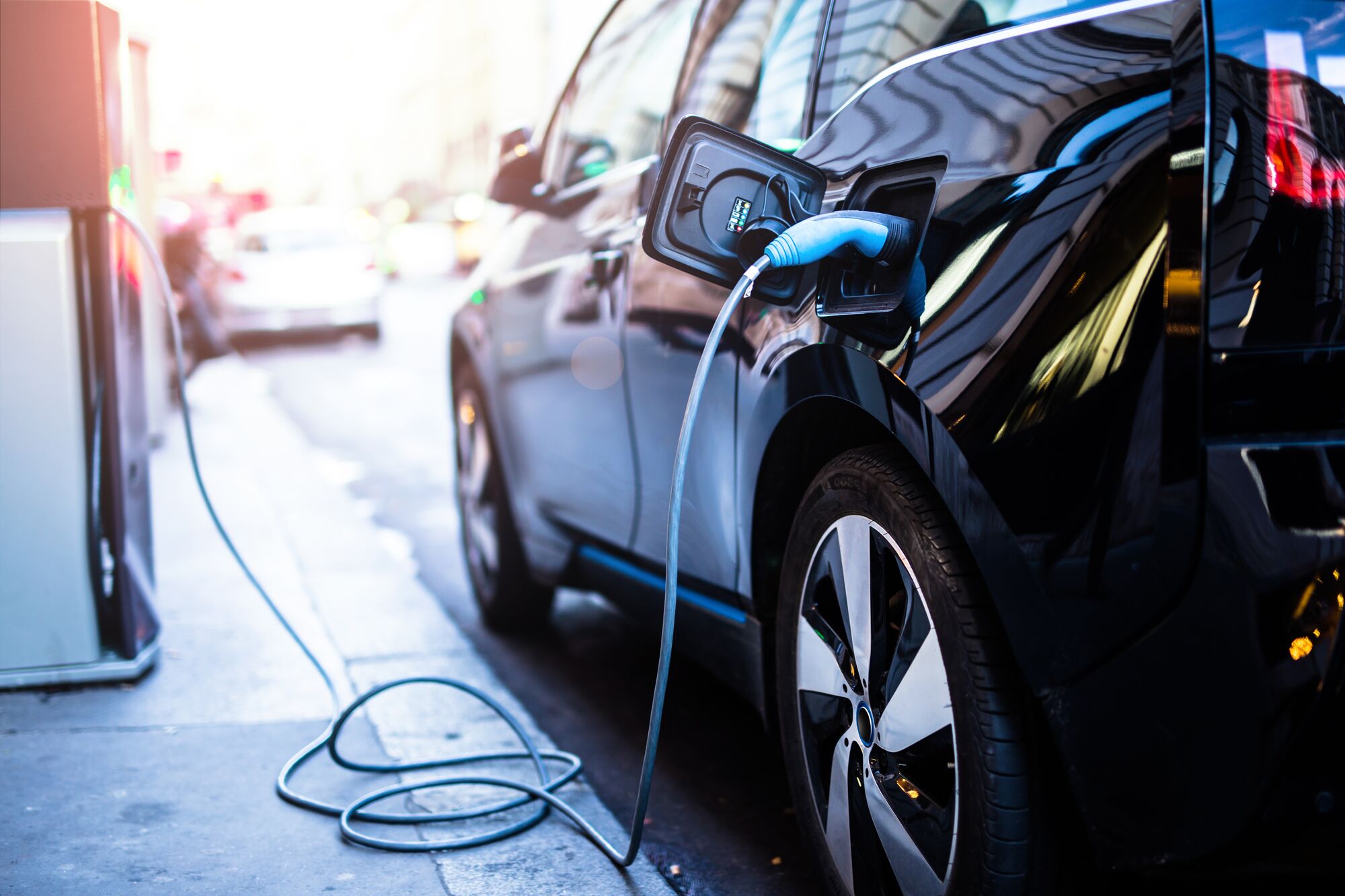 Charging modern electric car on the street 