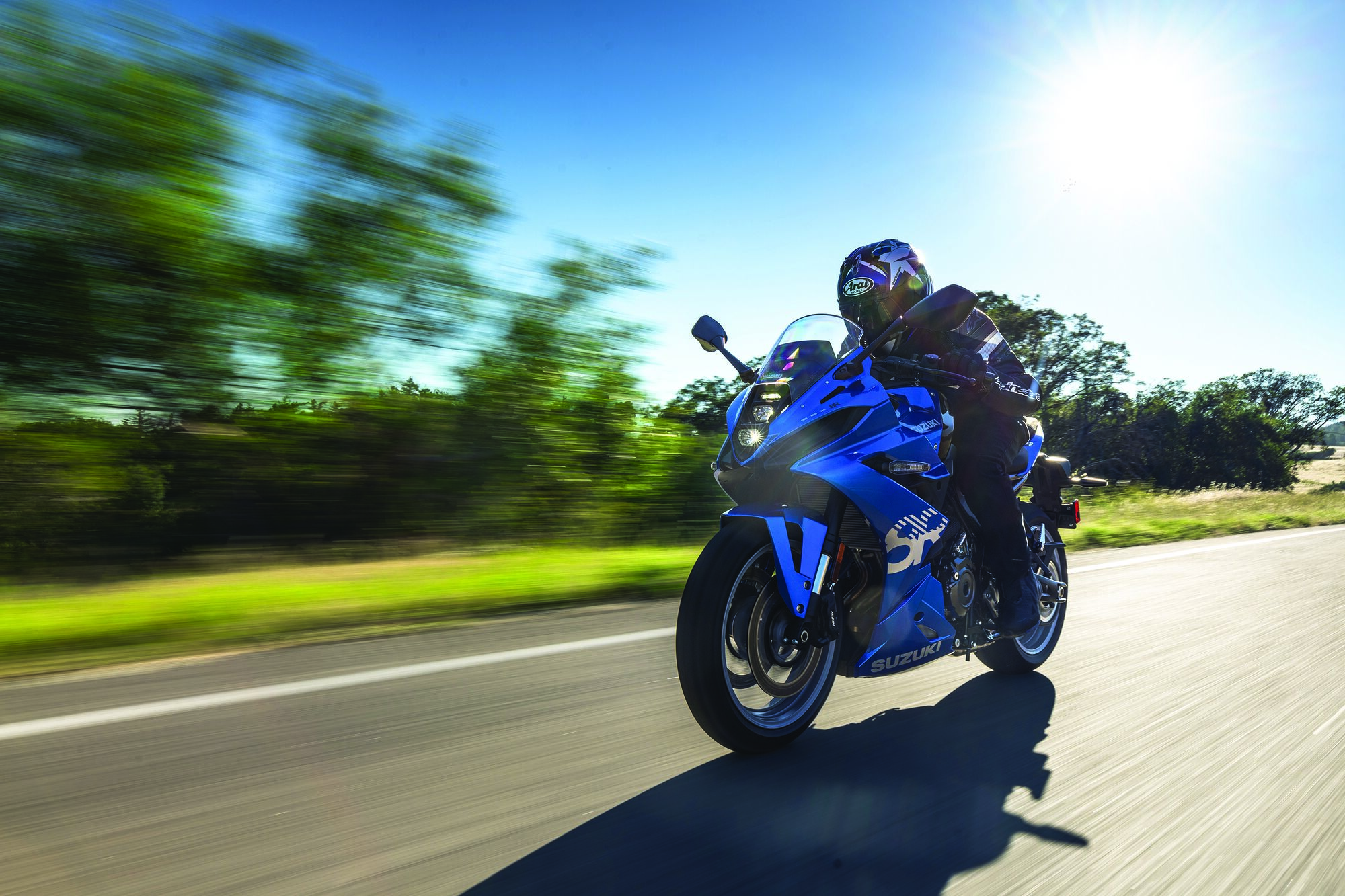 motorcycle driving down road at high speed