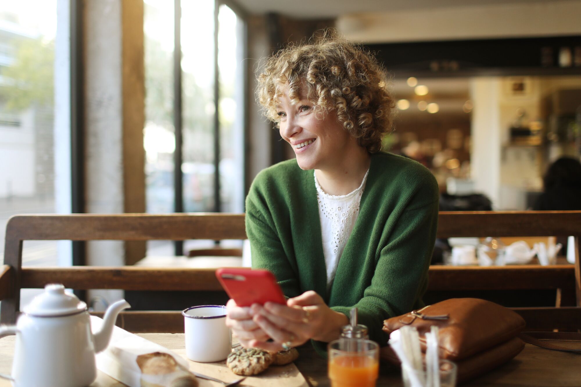 Woman in France at cafe with smart phone