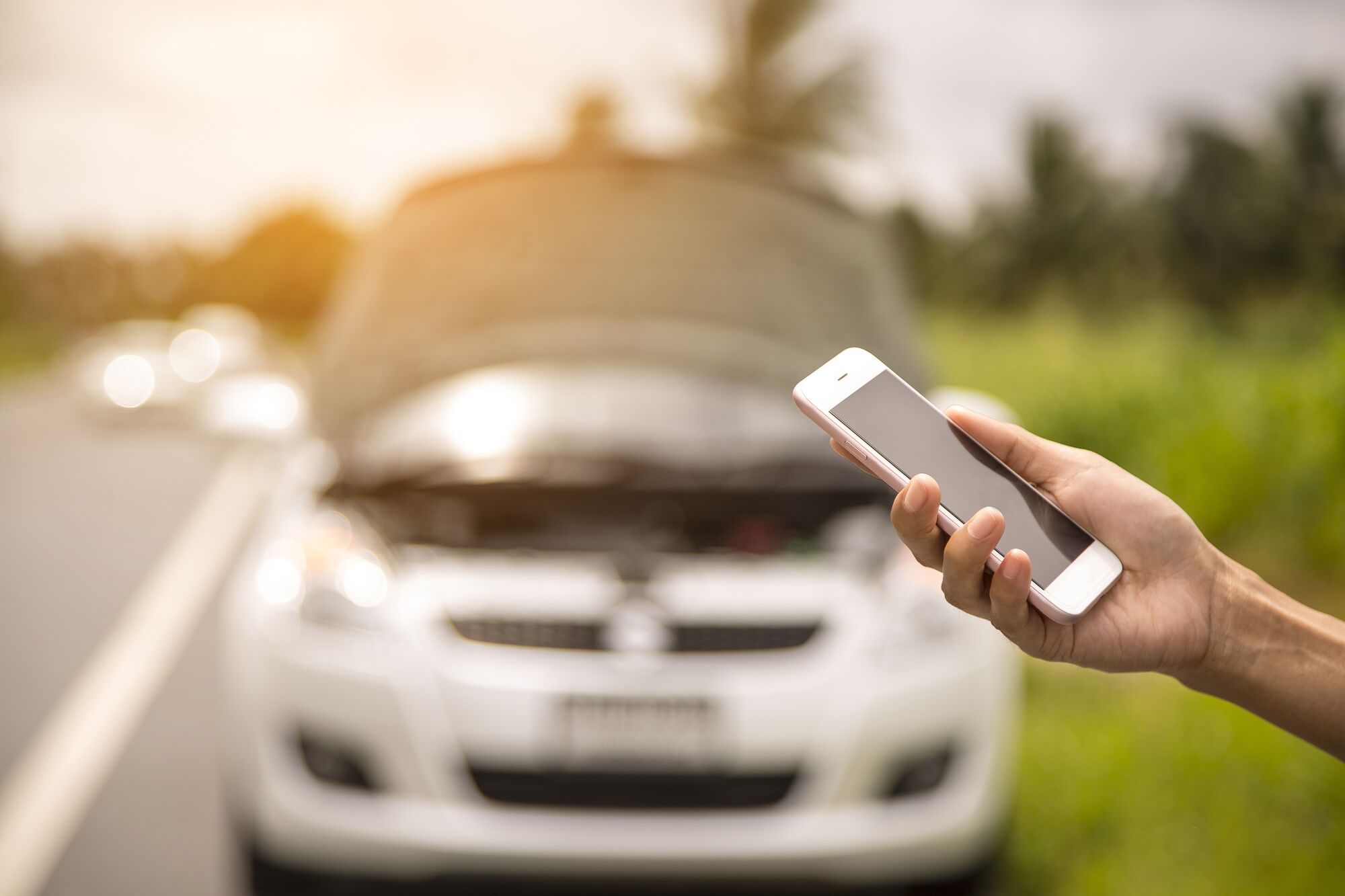 Using a mobile phone call a car mechanic because car was broken.