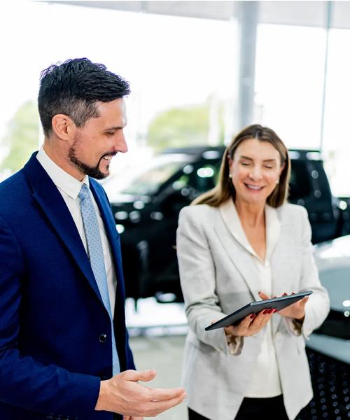 Coworkers talking at car dealership