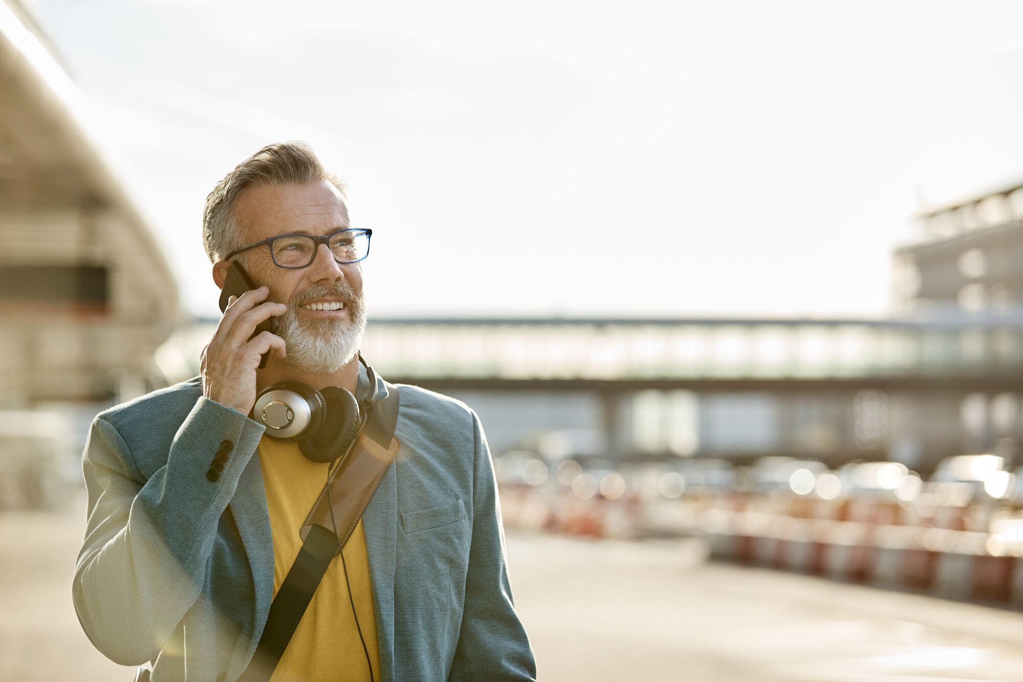 CL-MOBILE-ExcutiveManPhoneHeadphonesAirport-GettyImages-1173141313